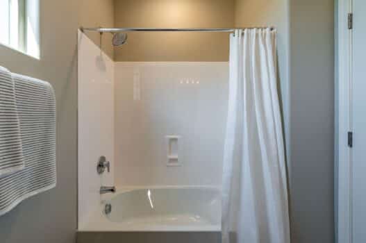 Model bathroom at our townhomes for rent in Queen Creek, AZ, featuring a bath / shower combo with a curtain.